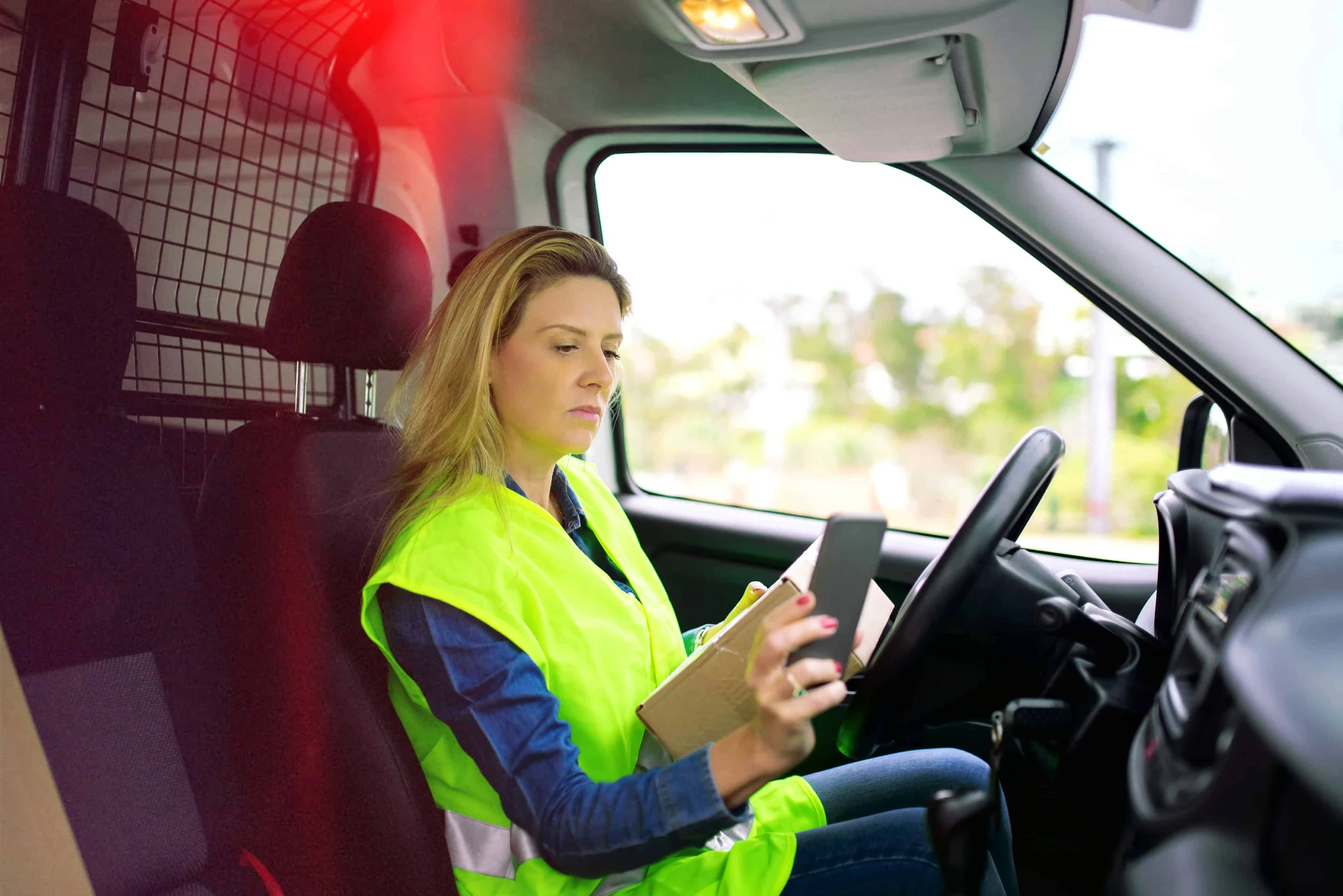 Real-time driver behaviour monitoring for improved fleet safety Fleet driver using tablet with car tracking system to monitor driving behaviour